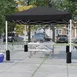 Flash Furniture JJ-GZ1010PKG-BK-GG 10'x10' Pop-up Canopy Tent, Black, Wheeled Case, UV Resistant 1 image